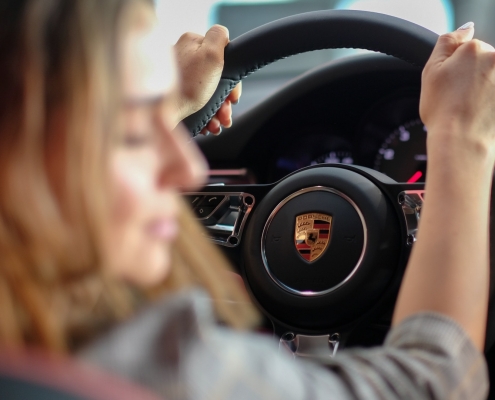 Woman A/B testing car features at a tradeshow