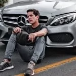 Influencers in front of a mercedes car