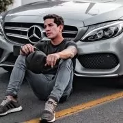 Influencers in front of a mercedes car