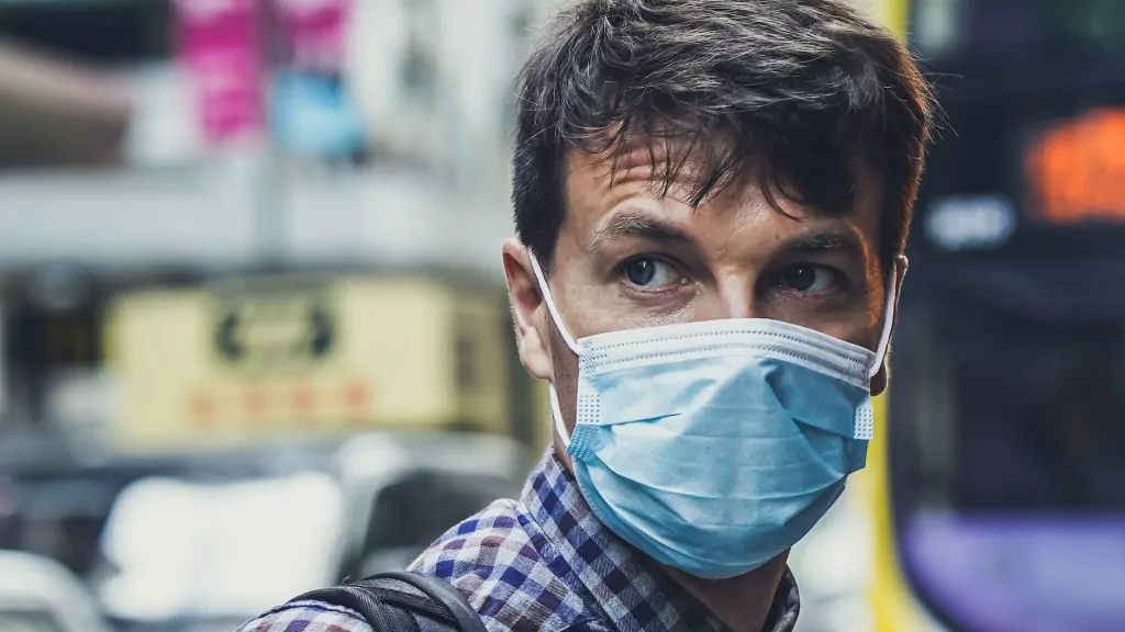 use face mask to protect from coronavirus, bacteria and airborne germs on trade shows and exhibition
